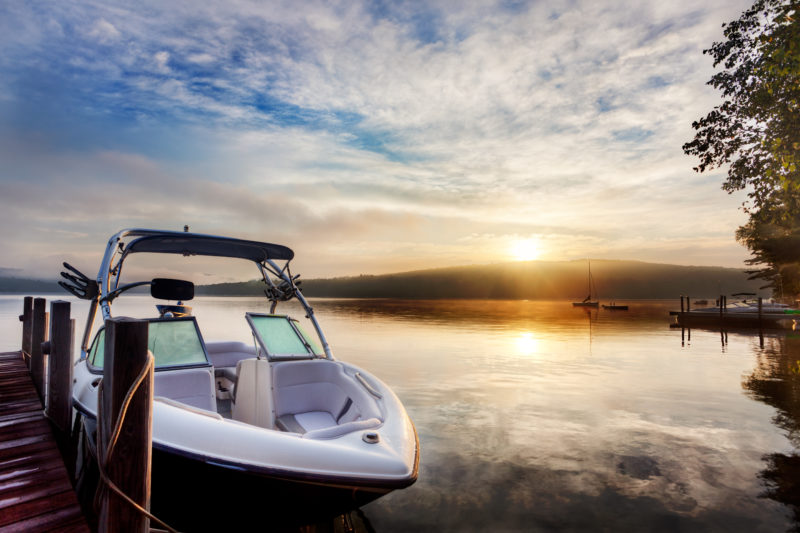 Sun and mist on a Summer New Hampshire boat dock at sunrise