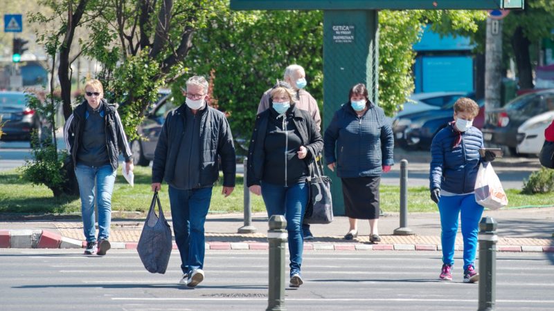 people walking across street