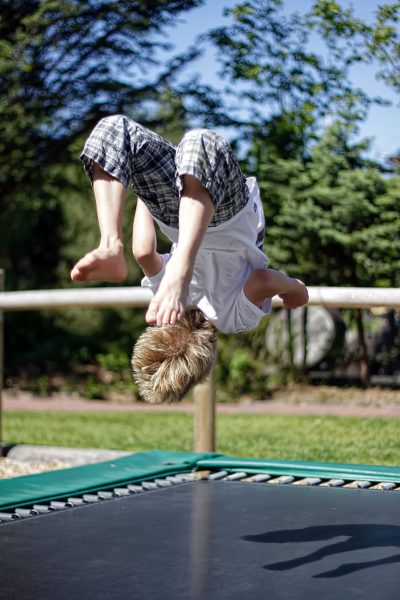 child doing back flip on trampoline