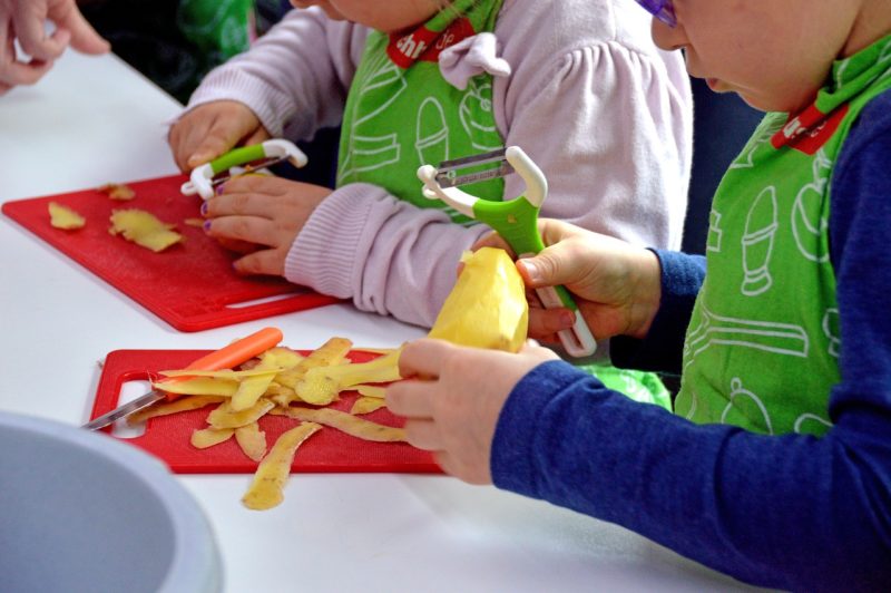 kids peeling veggies