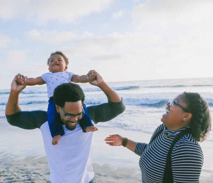 family laughing on beach