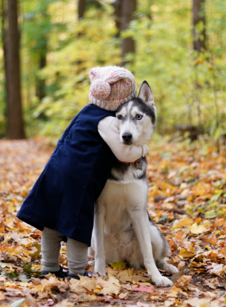 little girl hugging dog